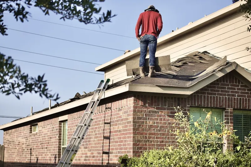 Professional roofer working on a residential roof in North Zanesville